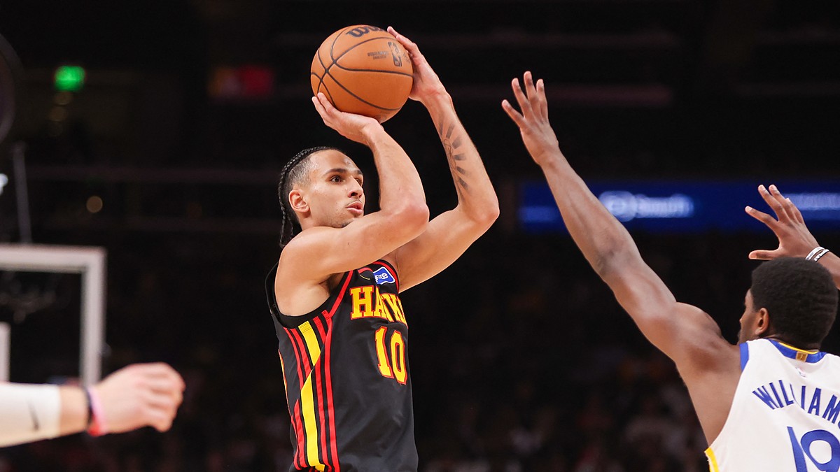 Atlanta Hawks forward Zaccharie Risacher rises for a jump shot with a Golden State defender contesting.