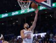 Oklahoma City Thunder guard Ajay Mitchell reaches for a layup as Phoenix Suns defenders look up from below the rim.