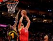 Houston Rockets center Alperen Şengün rises for a shot near the rim as Atlanta Hawks guard Nickeil Alexander-Walker contests.