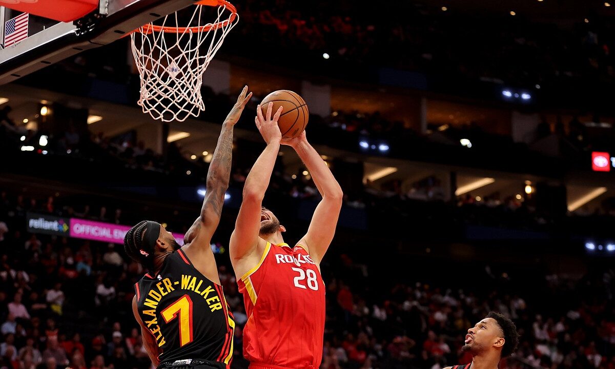 Houston Rockets center Alperen Şengün rises for a shot near the rim as Atlanta Hawks guard Nickeil Alexander-Walker contests.