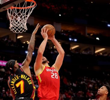 Houston Rockets center Alperen Şengün rises for a shot near the rim as Atlanta Hawks guard Nickeil Alexander-Walker contests.