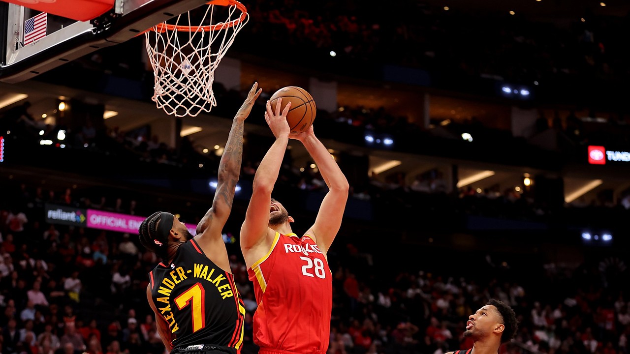 Houston Rockets center Alperen Şengün rises for a shot near the rim as Atlanta Hawks guard Nickeil Alexander-Walker contests.