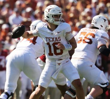 Texas quarterback Arch Manning cocks the ball back to throw as his offensive linemen pass block.