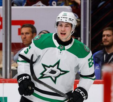 Dallas Stars right wing Arttu Hyry shouts in celebration in front of the glass, holding his stick low.