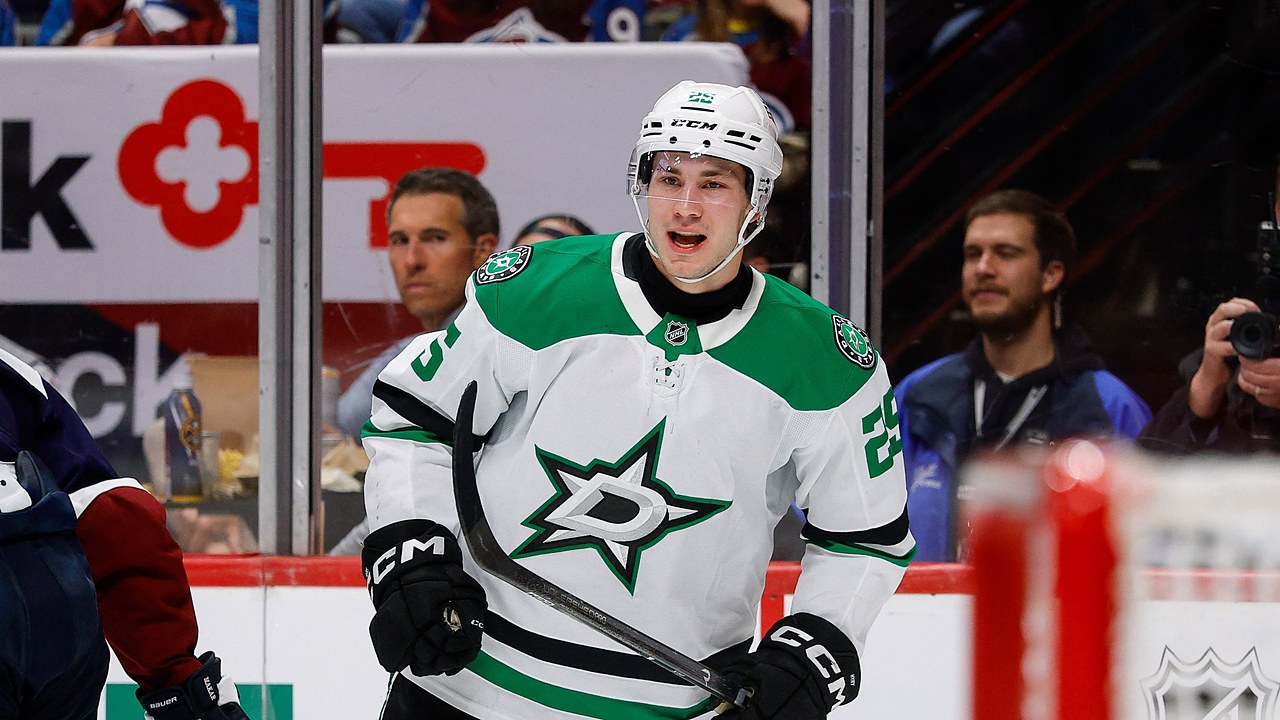 Dallas Stars right wing Arttu Hyry shouts in celebration in front of the glass, holding his stick low.
