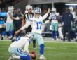 Dallas Cowboys kicker Brandon Aubrey plants his foot to kick as punter Bryan Anger holds the ball.