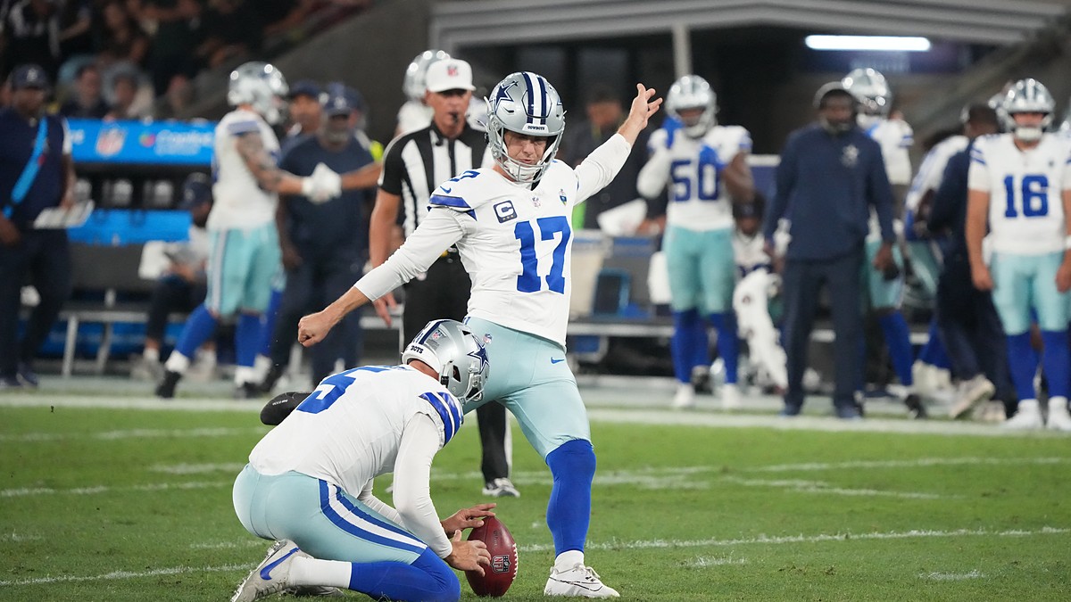 Dallas Cowboys kicker Brandon Aubrey plants his foot to kick as punter Bryan Anger holds the ball.