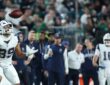 Dallas Cowboys tight end Brevyn Spann-Ford tracks a pass with his eyes as the ball drops toward his hands near the sideline.
