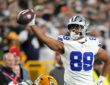 Dallas Cowboys tight end Brevyn Spann-Ford signals first down with the ball held out in one hand.