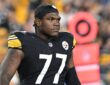 Pittsburgh Steelers offensive tackle Broderick Jones looks on from the field in a black No. 77 jersey and skullcap.