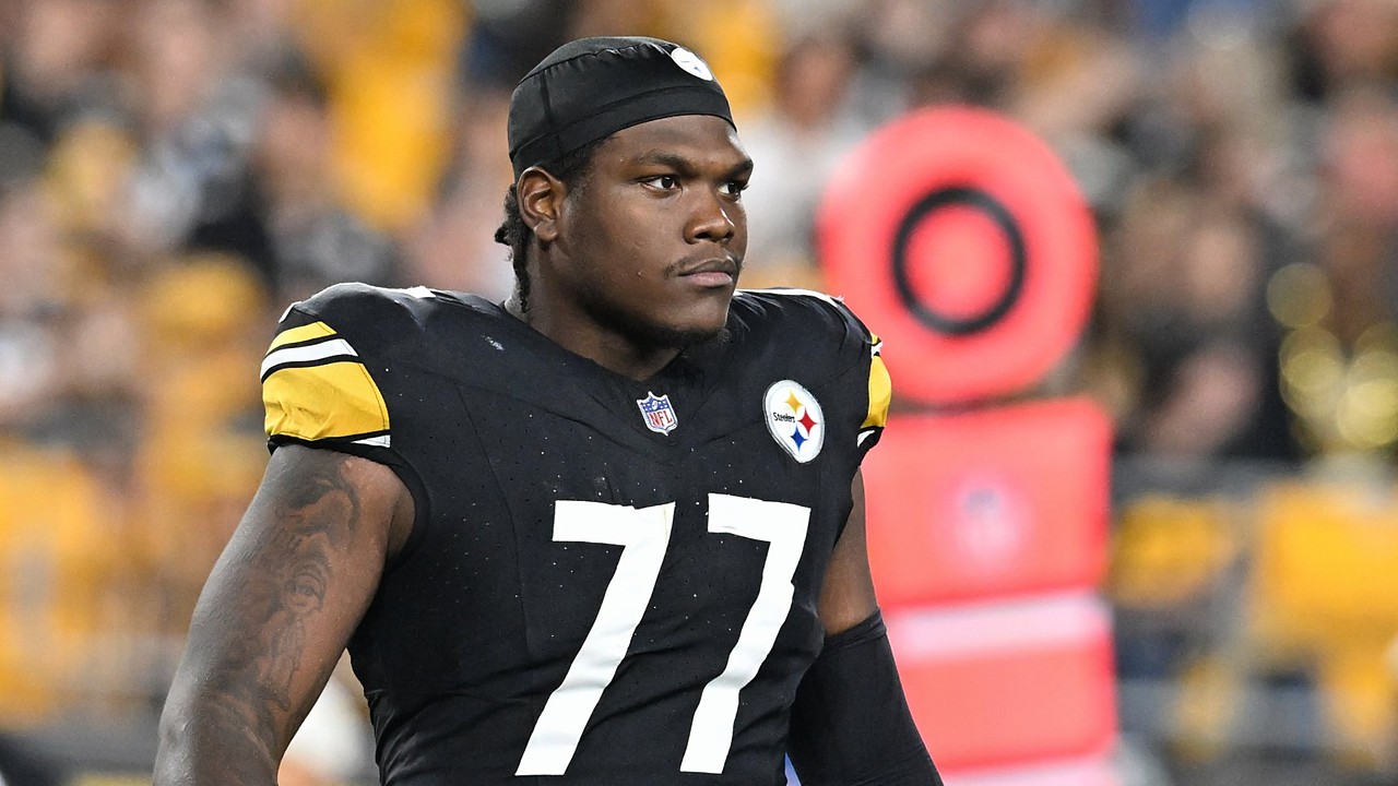 Pittsburgh Steelers offensive tackle Broderick Jones looks on from the field in a black No. 77 jersey and skullcap.