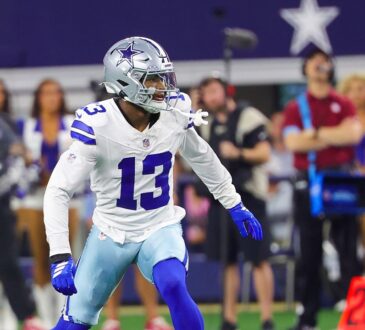 Dallas Cowboys safety Caleb Downs, wearing No. 13 in white, backpedals into coverage on the field at a home game.