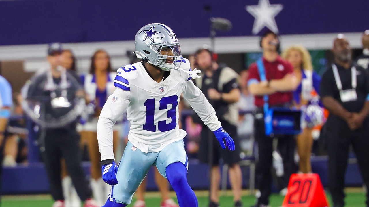 Dallas Cowboys safety Caleb Downs, wearing No. 13 in white, backpedals into coverage on the field at a home game.