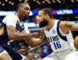 Dallas Mavericks forward Caleb Martin protects the ball with his right hand as New Orleans Pelicans forward Herbert Jones guards him.
