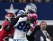 Dallas Cowboys wide receiver CeeDee Lamb secures a catch as Tampa Bay Buccaneers cornerback Keionte Scott reaches over his shoulder.