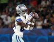 Dallas Cowboys wide receiver CeeDee Lamb catches the ball with both hands while running in stride.