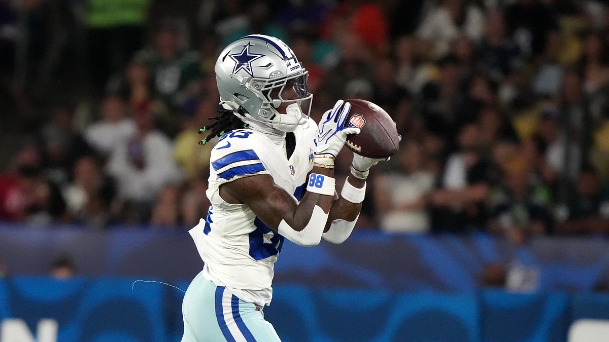 Dallas Cowboys wide receiver CeeDee Lamb catches the ball with both hands while running in stride.