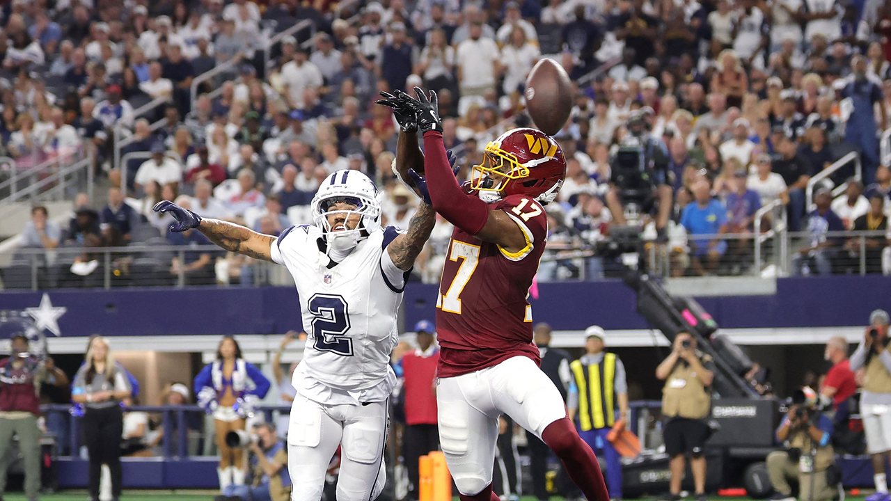 Dallas Cowboys cornerback Cobie Durant reaches to break up a pass in the end zone intended for Washington Commanders wide receiver Terry McLaurin.
