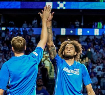 Mavericks forward Cooper Flagg and center Dereck Lively II high five before a game.