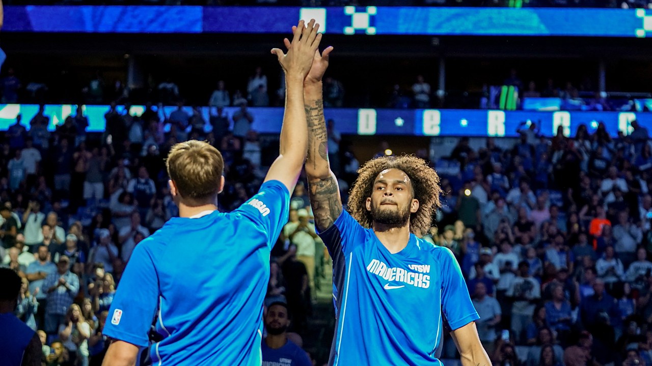 Mavericks forward Cooper Flagg and center Dereck Lively II high five before a game.