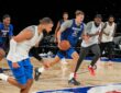 Mavericks forward Cooper Flagg dribbles up the court during a full-team scrimmage as teammates run alongside him.