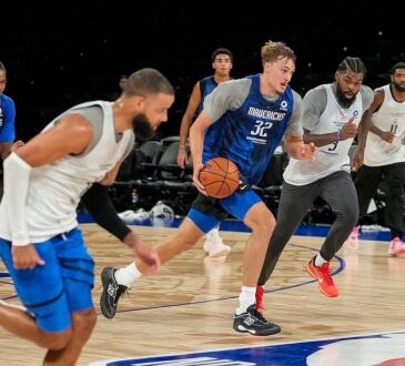 Mavericks forward Cooper Flagg dribbles up the court during a full-team scrimmage as teammates run alongside him.