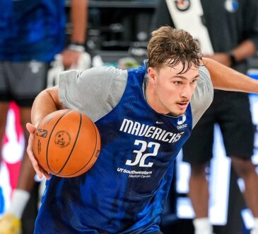 Mavericks forward Cooper Flagg dribbles hard to his right during practice, with an NBA China Games sign behind him.