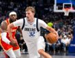 Dallas Mavericks forward Cooper Flagg drives with the ball in his right hand as an Atlanta Hawks defender trails.