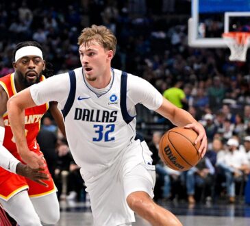 Dallas Mavericks forward Cooper Flagg drives with the ball in his right hand as an Atlanta Hawks defender trails.