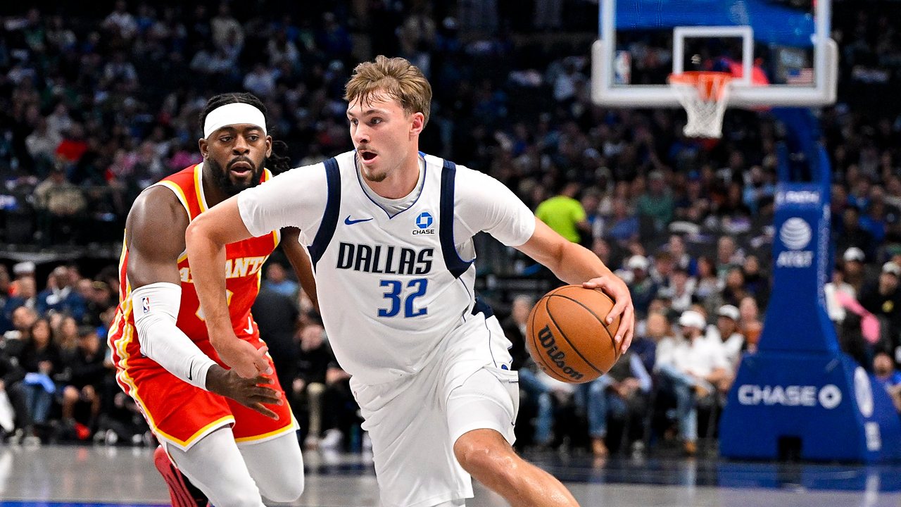 Dallas Mavericks forward Cooper Flagg drives with the ball in his right hand as an Atlanta Hawks defender trails.
