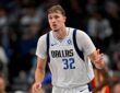 Dallas Mavericks forward Cooper Flagg celebrates as he heads back up the court in a white Dallas No. 32 jersey.