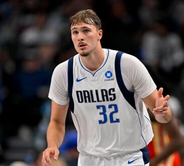 Dallas Mavericks forward Cooper Flagg celebrates as he heads back up the court in a white Dallas No. 32 jersey.