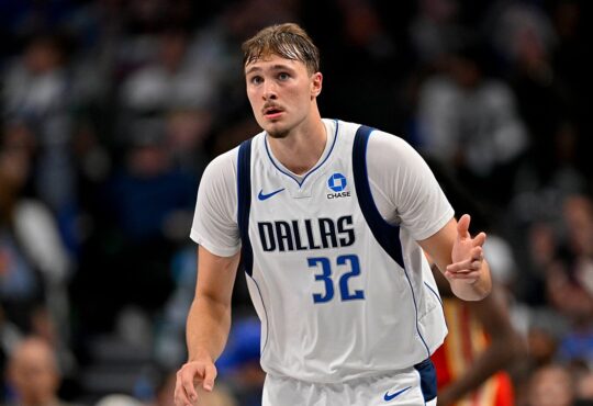 Dallas Mavericks forward Cooper Flagg celebrates as he heads back up the court in a white Dallas No. 32 jersey.