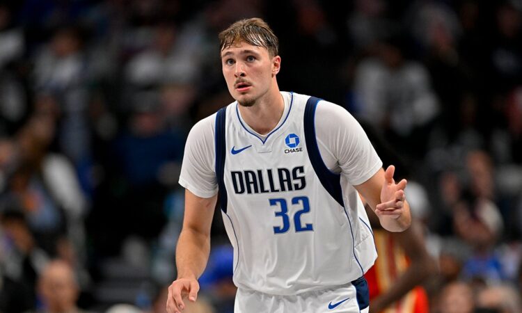Dallas Mavericks forward Cooper Flagg celebrates as he heads back up the court in a white Dallas No. 32 jersey.