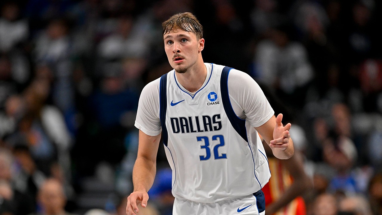 Dallas Mavericks forward Cooper Flagg celebrates as he heads back up the court in a white Dallas No. 32 jersey.