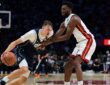 Dallas Mavericks forward Cooper Flagg (32) drives to the basket against Miami Heat forward Andrew Wiggins (22) during the fourth quarter at Kaseya Center on Oct. 26, 2026.