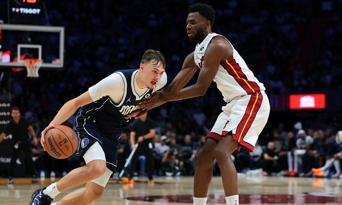 Dallas Mavericks forward Cooper Flagg (32) drives to the basket against Miami Heat forward Andrew Wiggins (22) during the fourth quarter at Kaseya Center on Oct. 26, 2026.