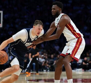 Dallas Mavericks forward Cooper Flagg (32) drives to the basket against Miami Heat forward Andrew Wiggins (22) during the fourth quarter at Kaseya Center on Oct. 26, 2026.