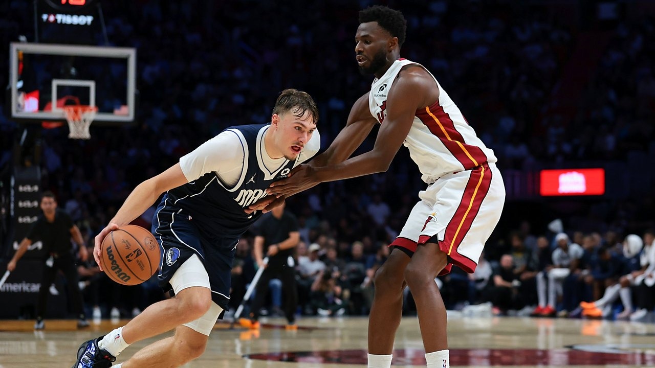 Dallas Mavericks forward Cooper Flagg (32) drives to the basket against Miami Heat forward Andrew Wiggins (22) during the fourth quarter at Kaseya Center on Oct. 26, 2026.