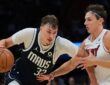 Dallas Mavericks forward Cooper Flagg drives with the ball in his right hand as Miami Heat guard Pelle Larsson defends.
