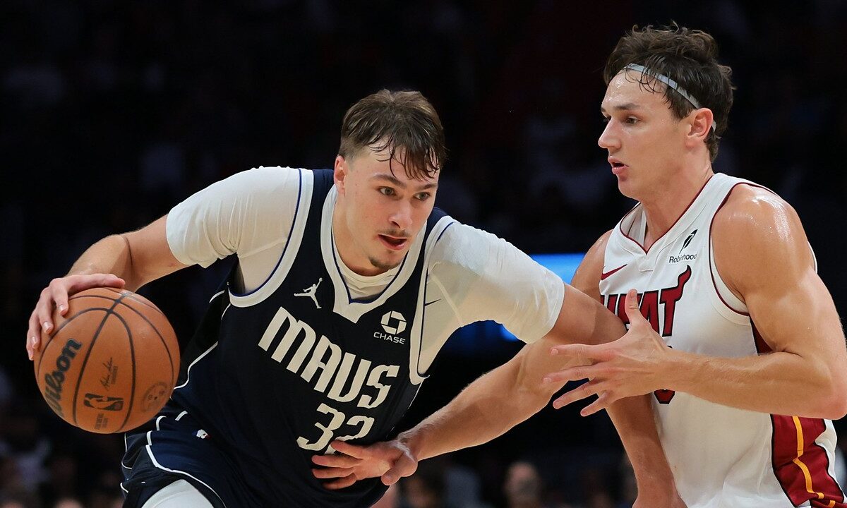 Dallas Mavericks forward Cooper Flagg drives with the ball in his right hand as Miami Heat guard Pelle Larsson defends.
