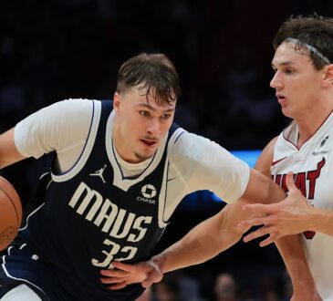Dallas Mavericks forward Cooper Flagg drives with the ball in his right hand as Miami Heat guard Pelle Larsson defends.