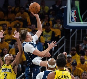 Dallas Mavericks forward Cooper Flagg rises for a one-handed shot as Indiana Pacers guard Andrew Nembhard contests with both hands up.
