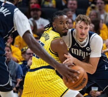 Dallas Mavericks forward Cooper Flagg fights for position against Indiana Pacers guard Aaron Nesmith as a teammate handles the ball.