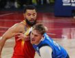 Mavericks forward Cooper Flagg shouts as he drives into Rockets guard Fred VanVleet, who wraps an arm around him.