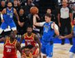 Dallas Mavericks forward Cooper Flagg pulls in a pass with one hand above a group of Houston Rockets players.