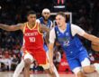 Dallas Mavericks forward Cooper Flagg dribbles toward the lane as Houston Rockets defenders guard him.