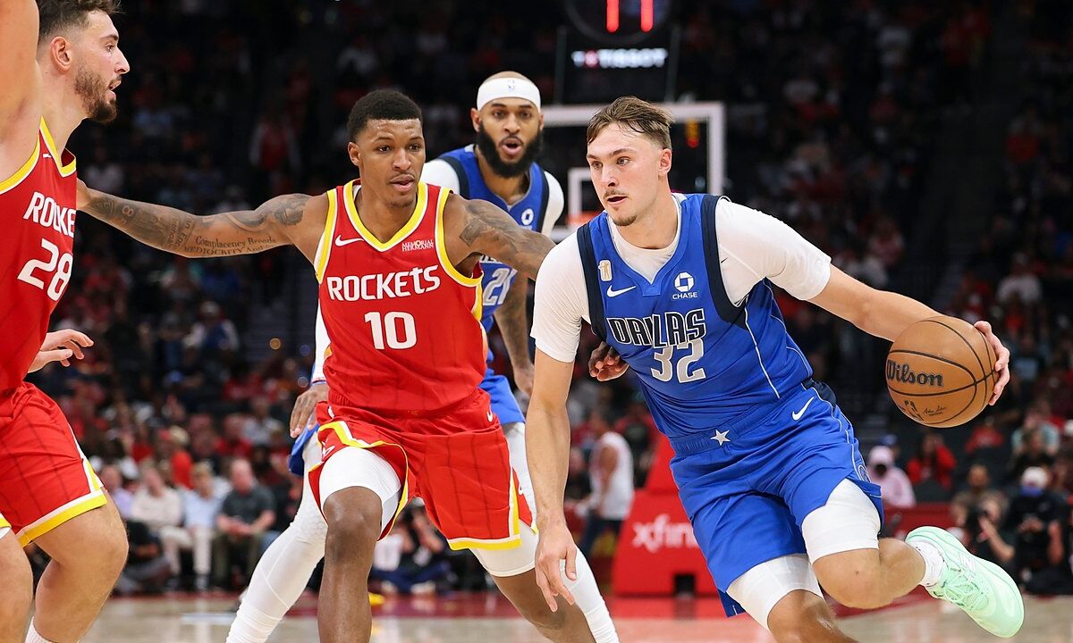 Dallas Mavericks forward Cooper Flagg dribbles toward the lane as Houston Rockets defenders guard him.