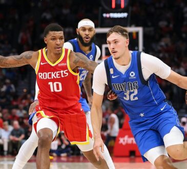 Dallas Mavericks forward Cooper Flagg dribbles toward the lane as Houston Rockets defenders guard him.