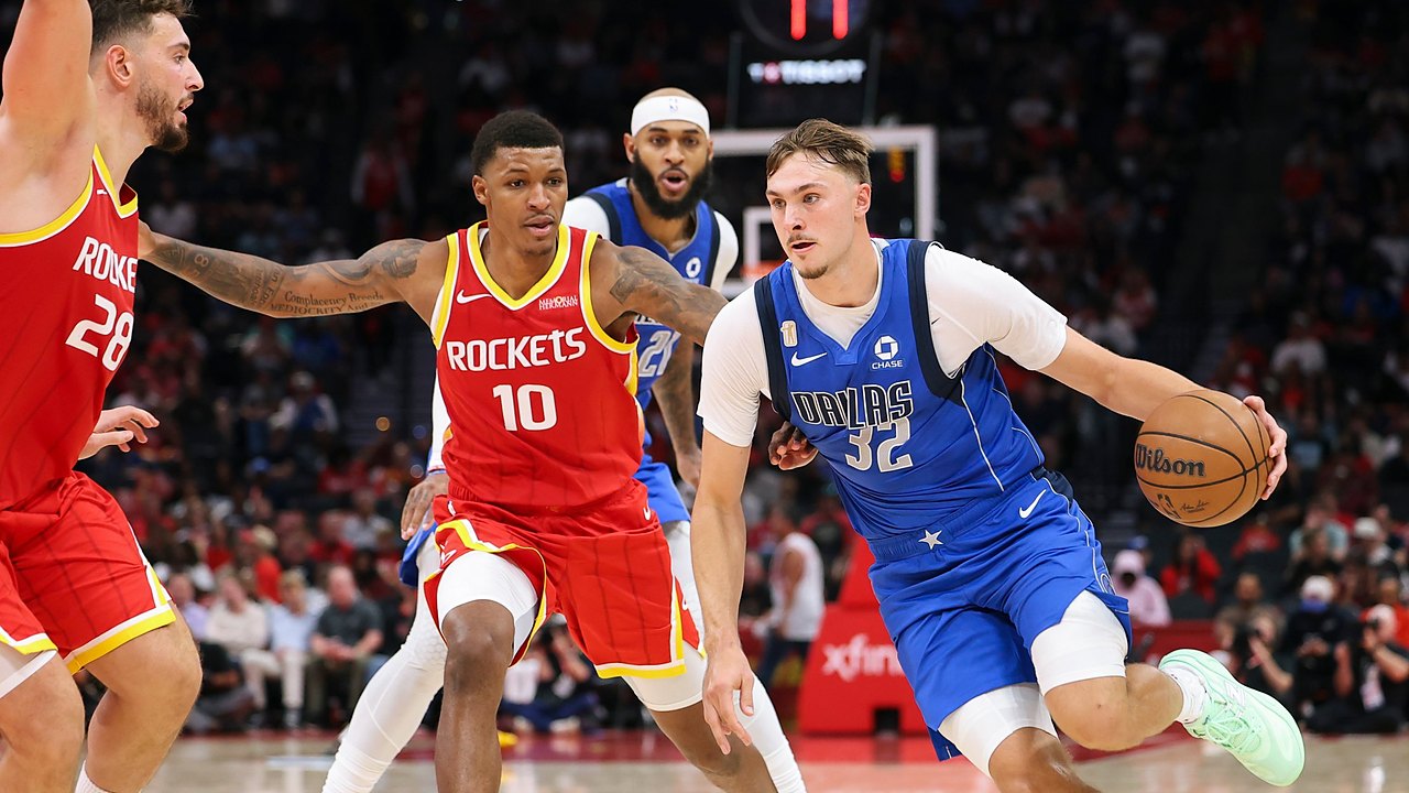 Dallas Mavericks forward Cooper Flagg dribbles toward the lane as Houston Rockets defenders guard him.